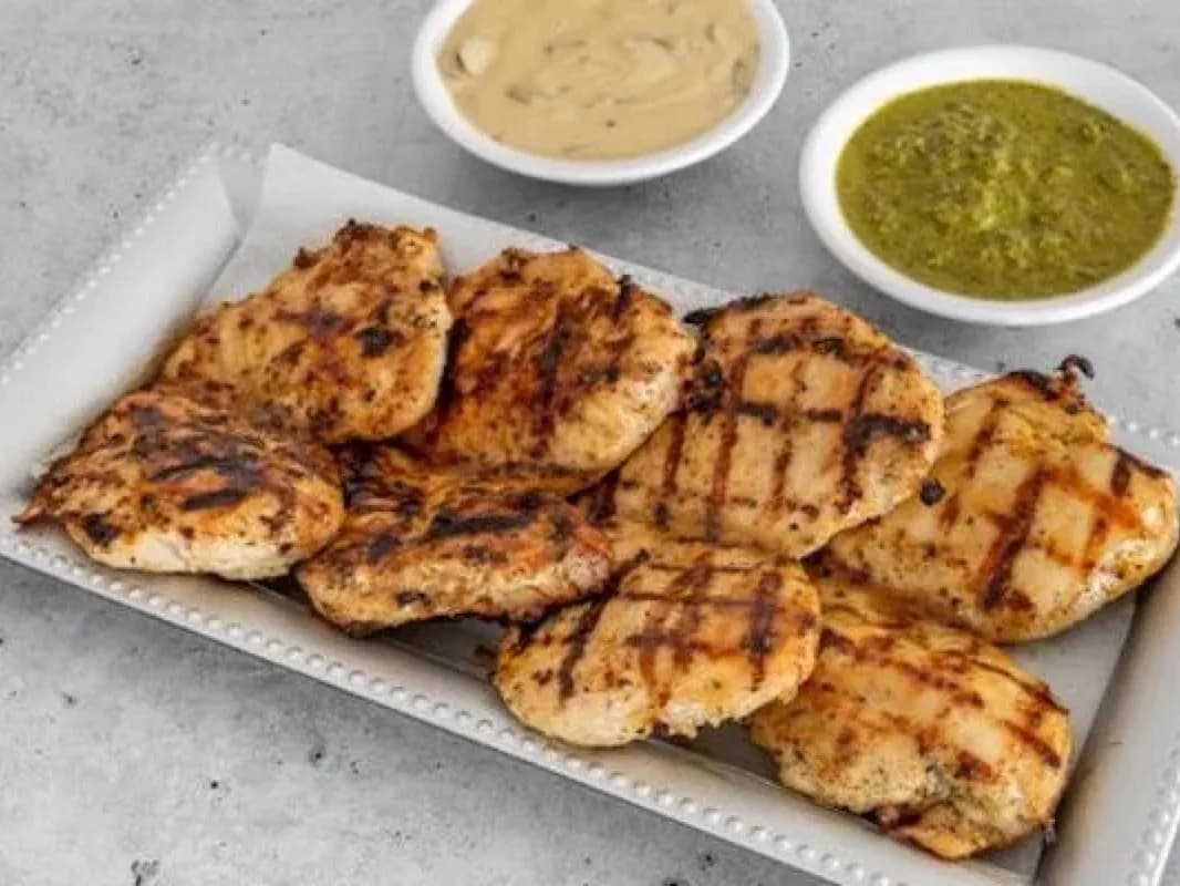 Grilled chicken breasts on a tray